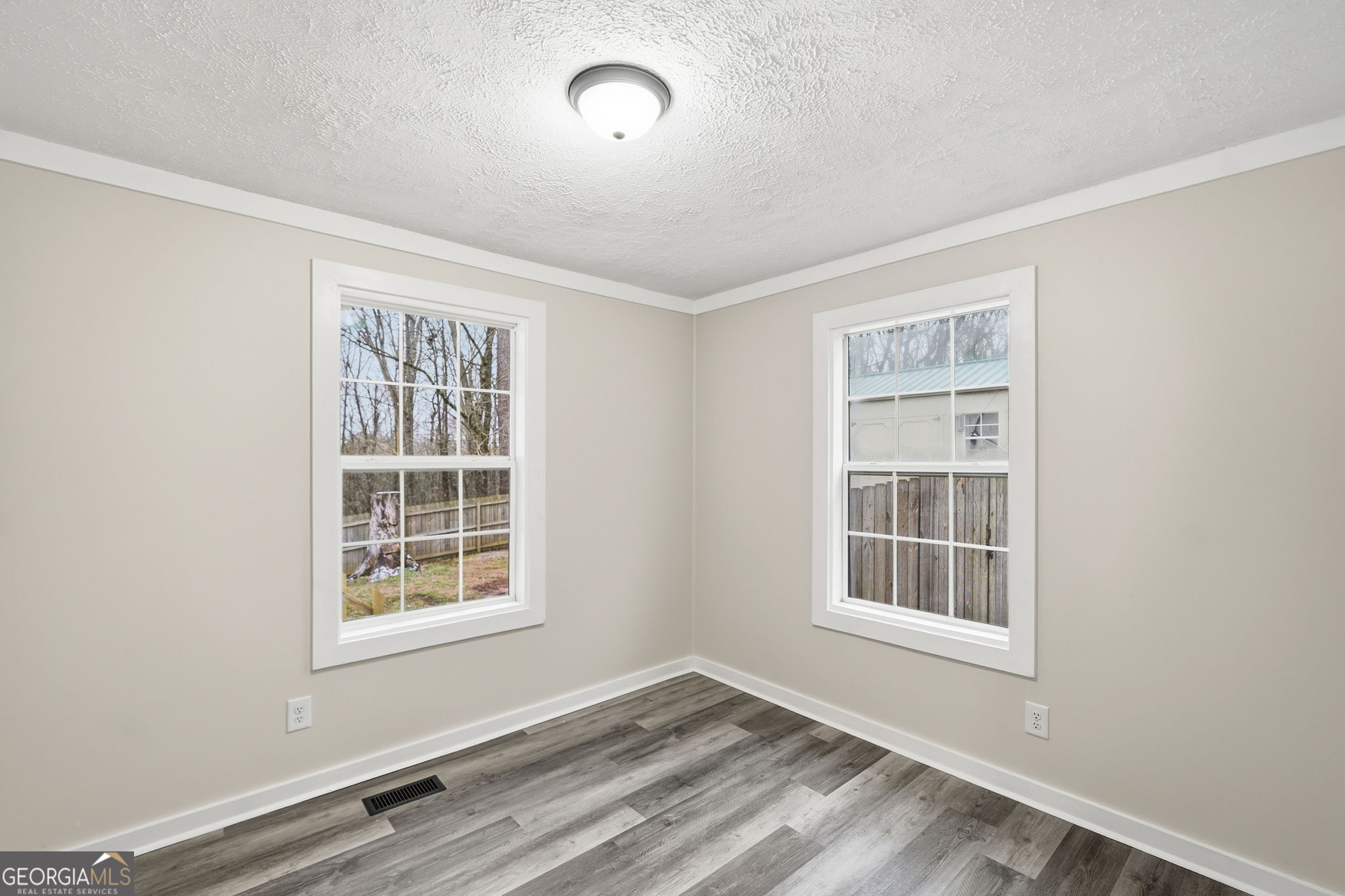 1734 Ball Ground Road Ball Ground, GA 30107 - Photo 26 of 31 an empty room with windows