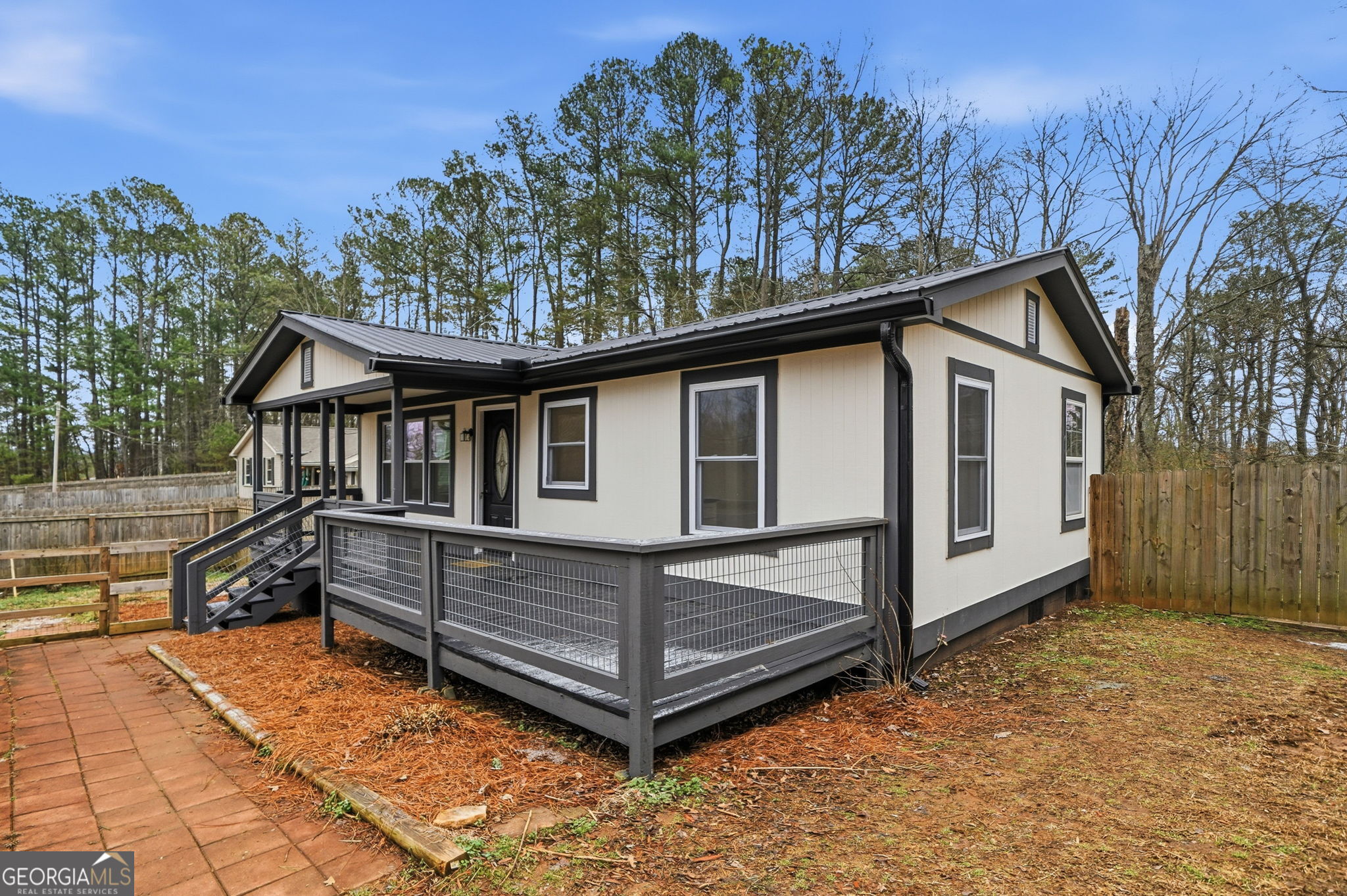 1734 Ball Ground Road Ball Ground, GA 30107 - Photo 4 of 31 a view of a house with a large window and wooden fence