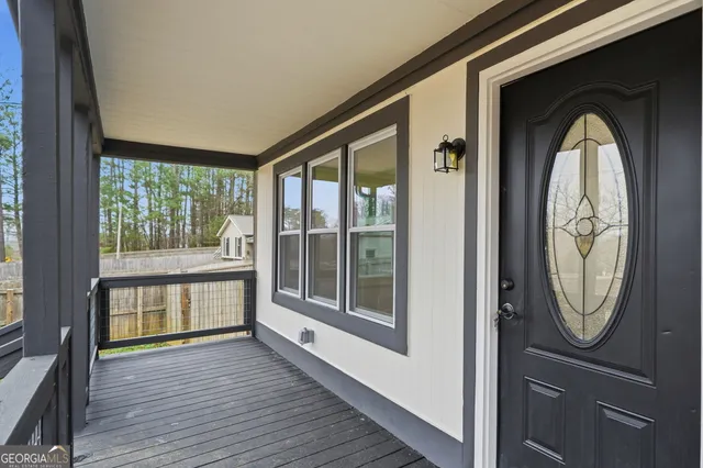 a view of a house with a yard and large tree
