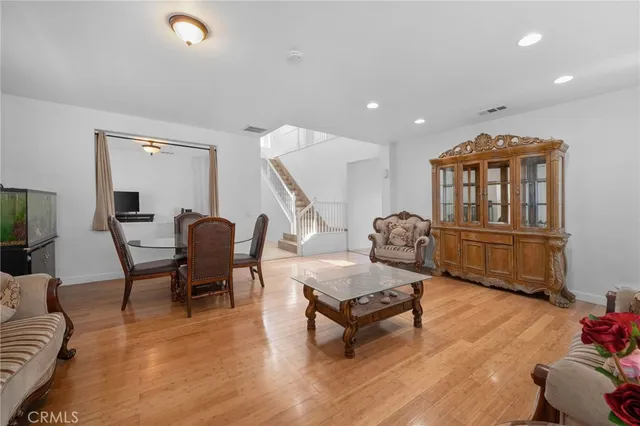 a living room with furniture and a table with wooden floor