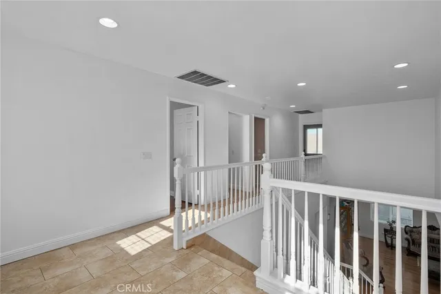 a bedroom with furniture and a wooden floor