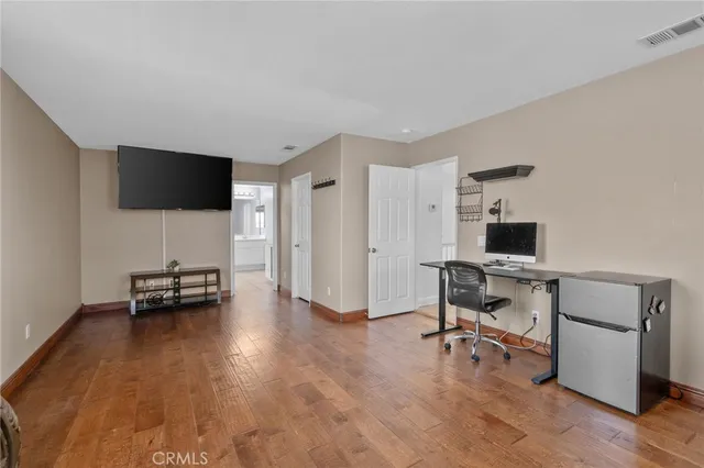 a spacious bathroom with a double vanity sink a large mirror and a bathtub