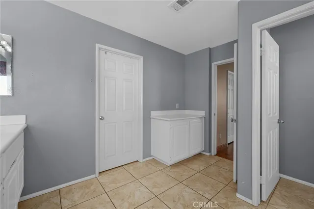 a room with a bed and wooden floor