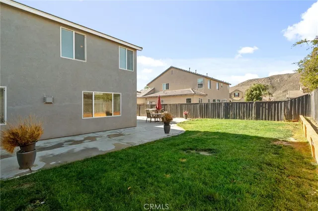an aerial view of residential houses with outdoor space and ocean view
