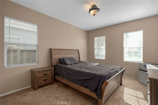 a bedroom with a bed and a television