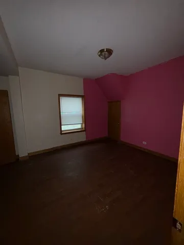 a view of a livingroom with an empty space and a window