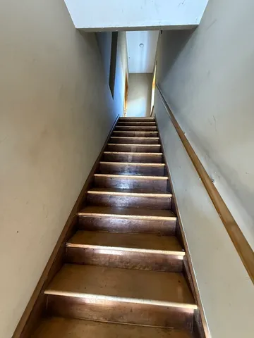 a view of a living room with furniture and wooden floor