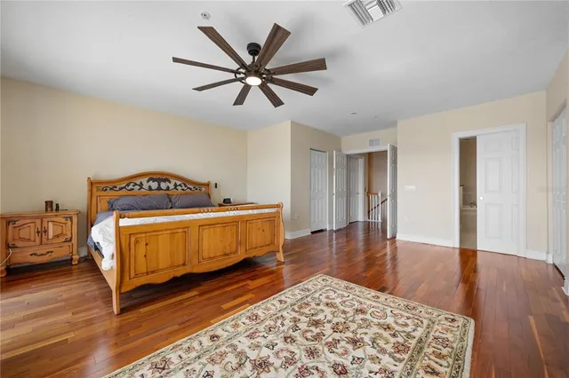 a bedroom with a bed and a tv on the dresser