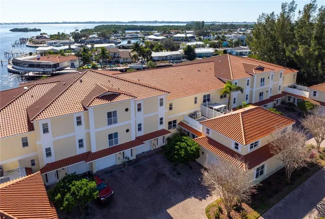 an aerial view of residential houses with outdoor space and swimming pool