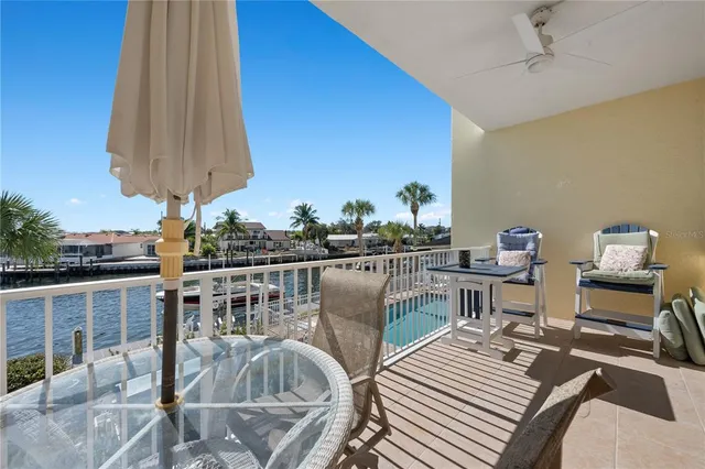 a kitchen with a table chairs refrigerator and cabinets