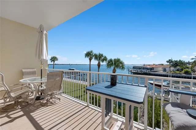 a dining room with kitchen island stainless steel appliances furniture a dining table and chairs with wooden floor