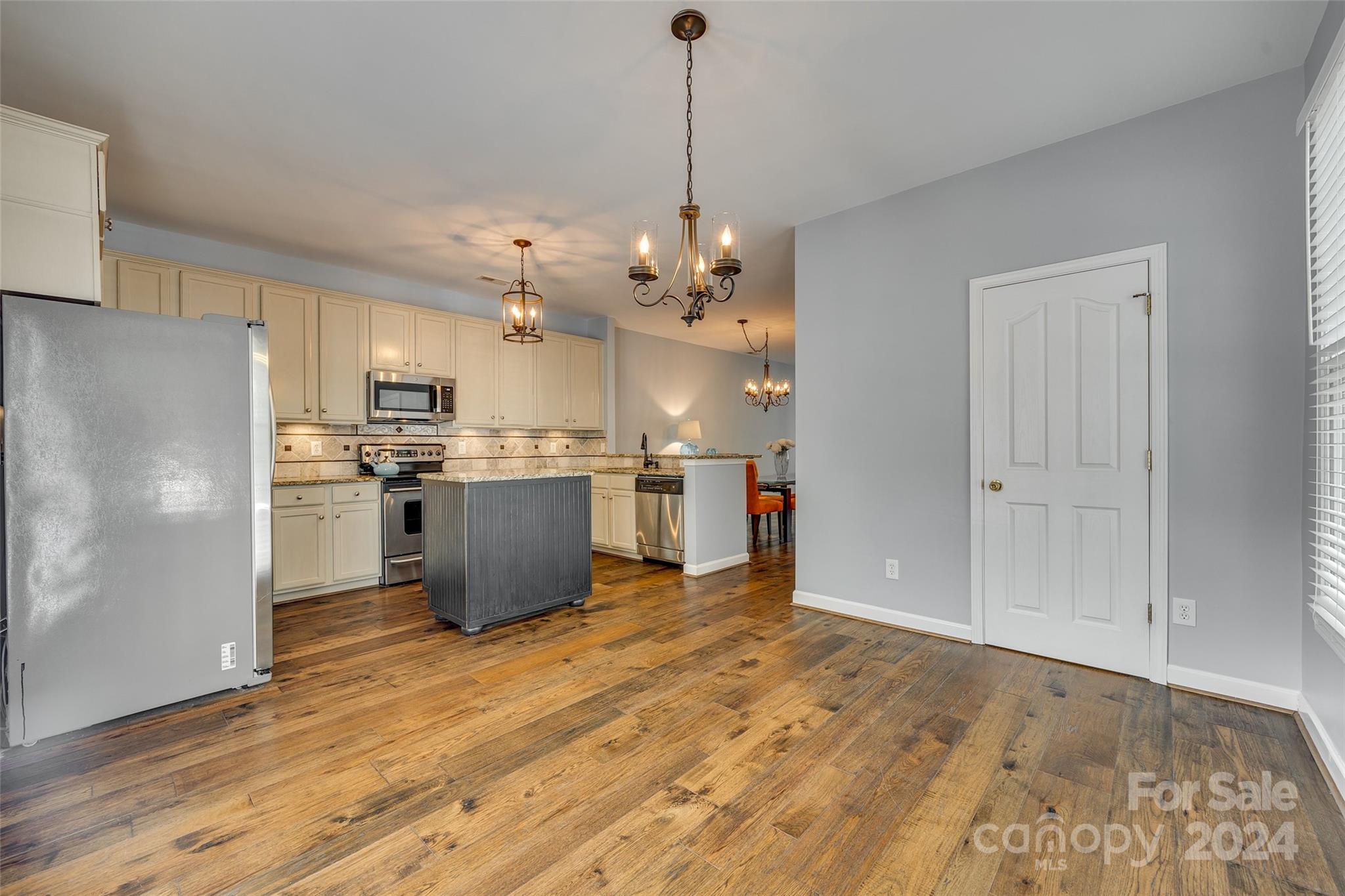 1107 Market Street Fort Mill, SC 29708 - Photo 12 of 30 a kitchen with stainless steel appliances kitchen island a refrigerator sink and cabinets
