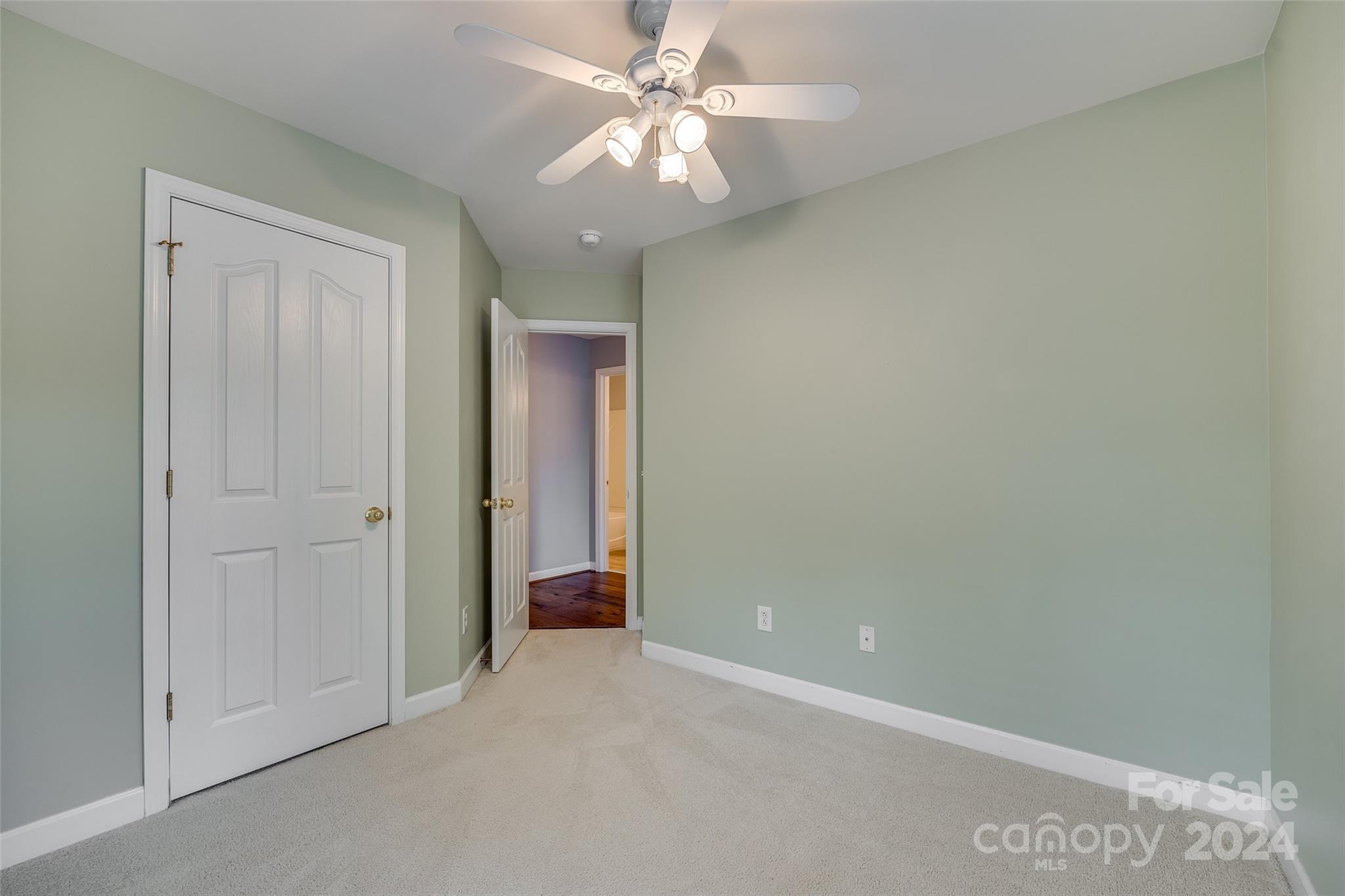 1107 Market Street Fort Mill, SC 29708 - Photo 23 of 30 an empty room with a ceiling fan and a window