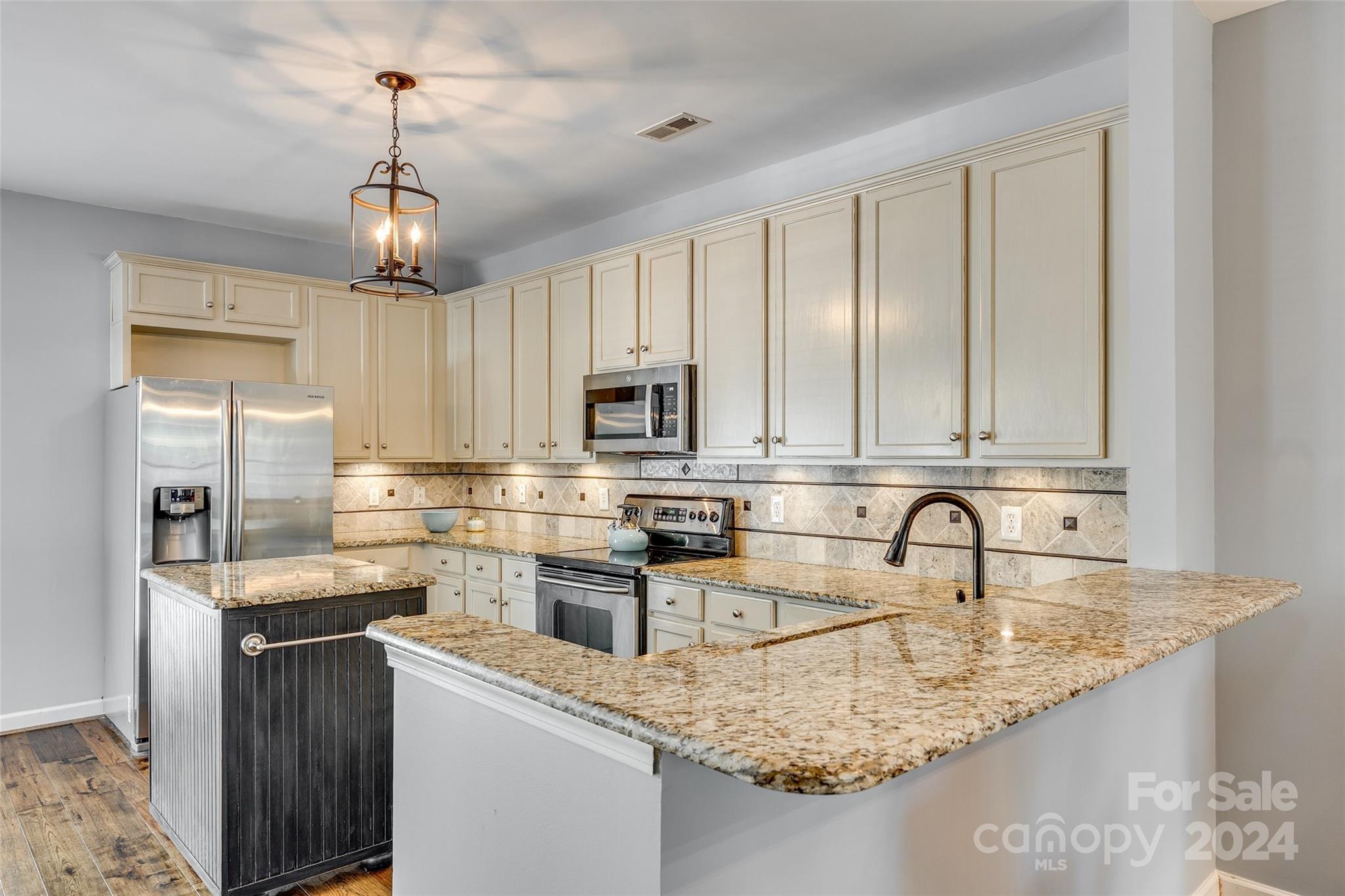1107 Market Street Fort Mill, SC 29708 - Photo 4 of 30 a kitchen with stainless steel appliances granite countertop a sink a stove and cabinets