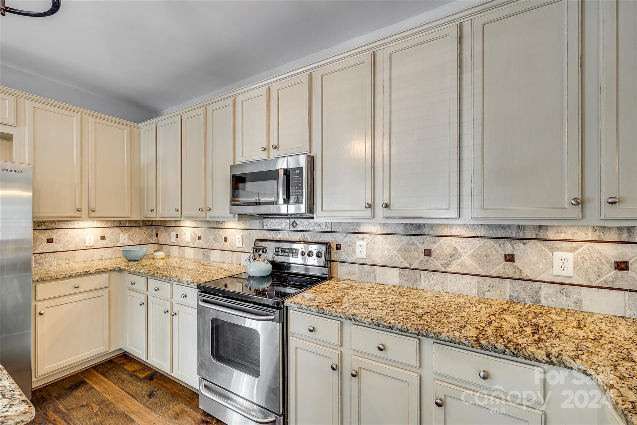 1107 Market Street Fort Mill, SC 29708 - Photo 5 of 30 a kitchen with granite countertop white cabinets and white appliances