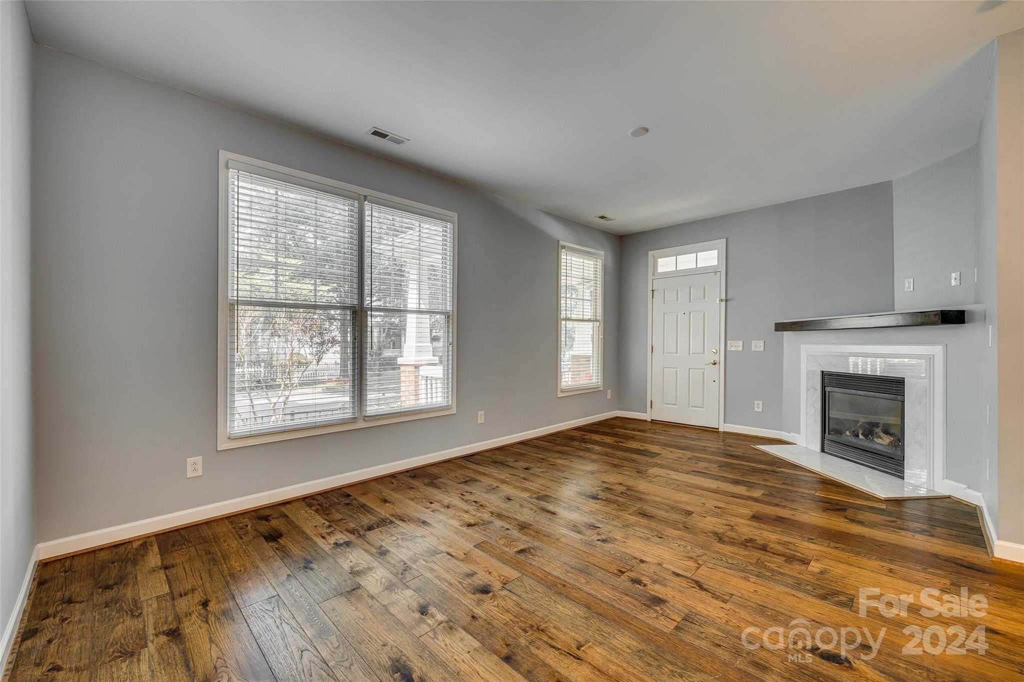 1107 Market Street Fort Mill, SC 29708 - Photo 7 of 30 a view of an empty room with a fireplace and a window