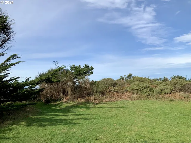 a view of a field with a house in background