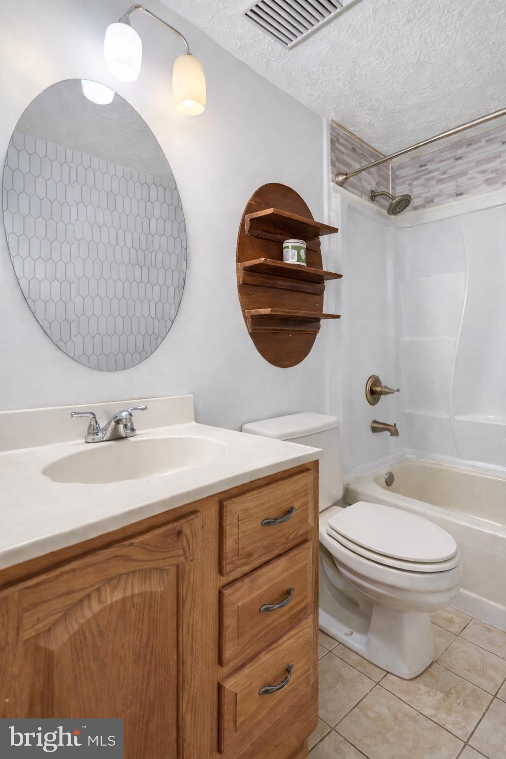 7467 Lone Star Road Lorton, VA 22079 - Photo 11 of 21 a bathroom with a toilet a sink and a mirror