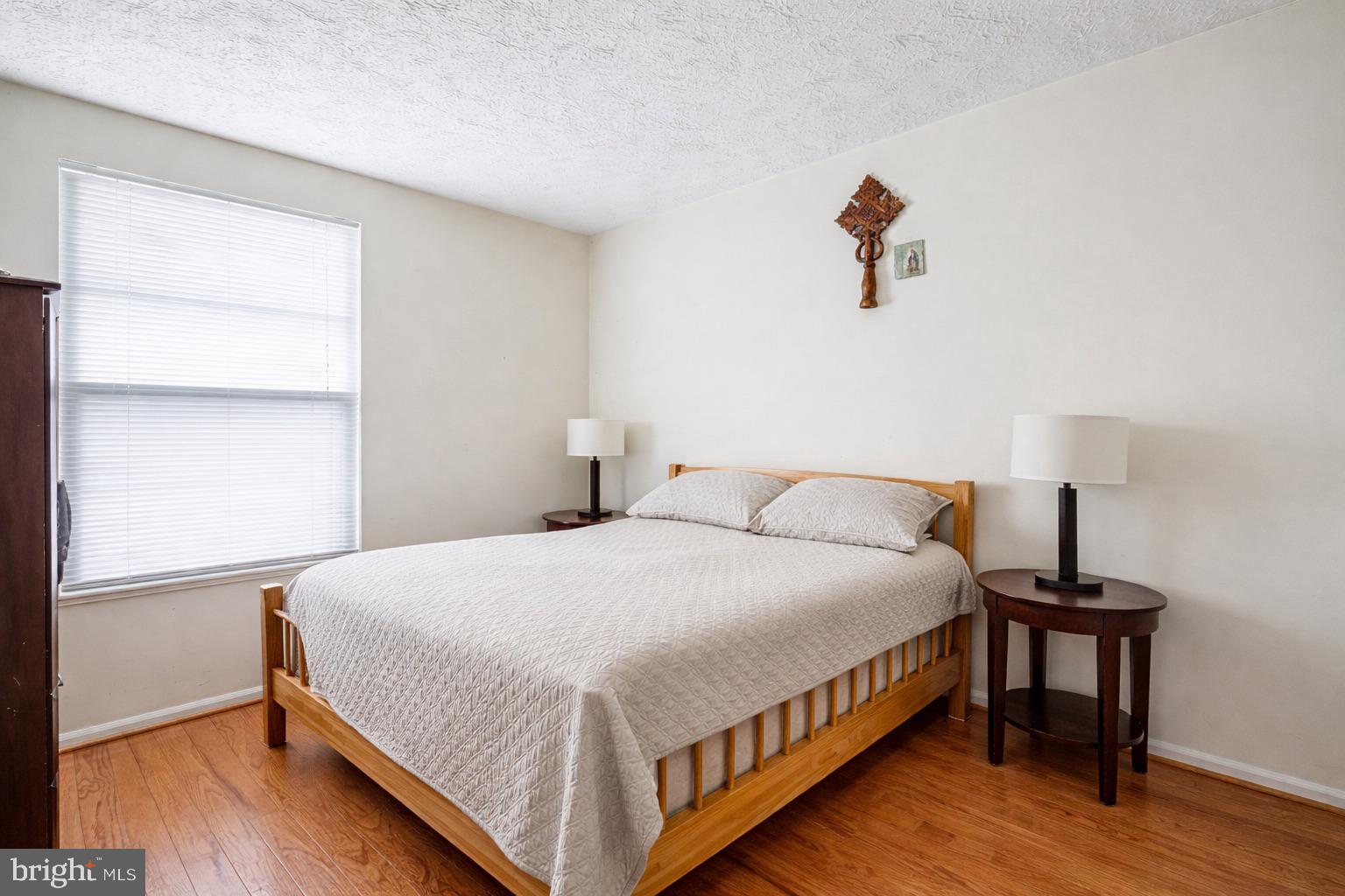 7467 Lone Star Road Lorton, VA 22079 - Photo 12 of 21 a bedroom with a bed and wooden floor