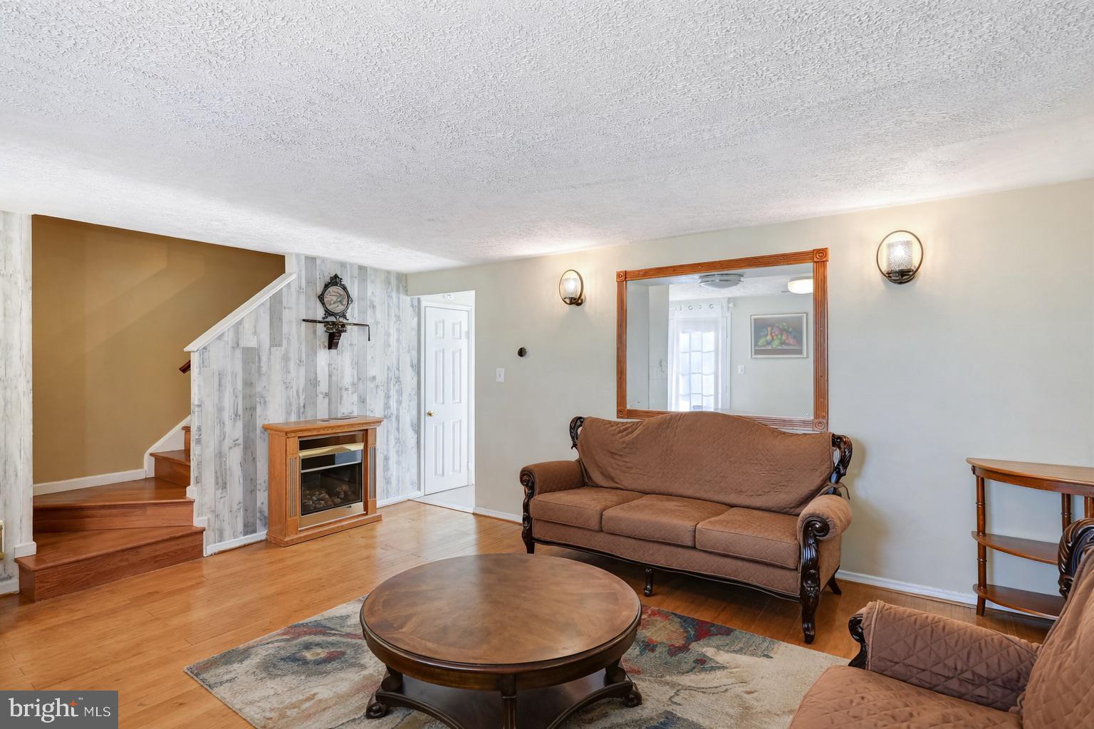 7467 Lone Star Road Lorton, VA 22079 - Photo 5 of 21 a living room with furniture and a fireplace