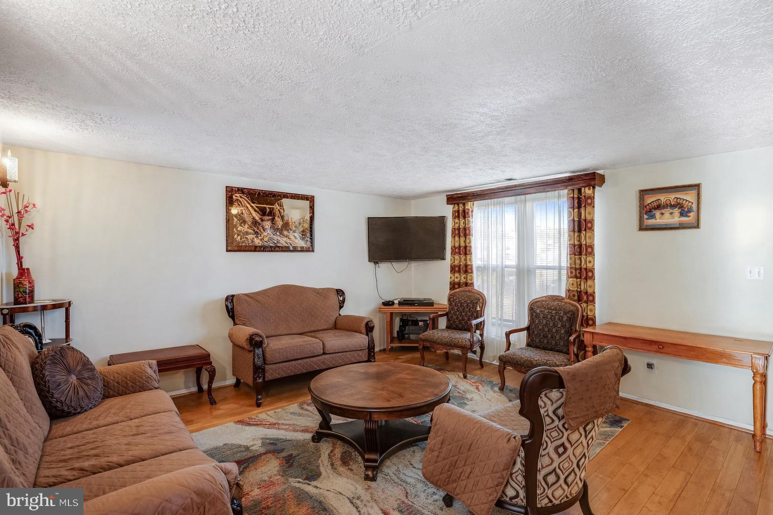 7467 Lone Star Road Lorton, VA 22079 - Photo 6 of 21 a living room with furniture a rug and a window