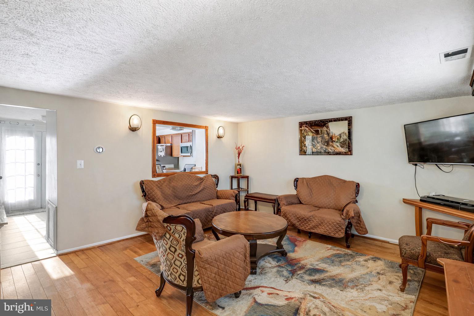 7467 Lone Star Road Lorton, VA 22079 - Photo 7 of 21 a living room with furniture and a flat screen tv