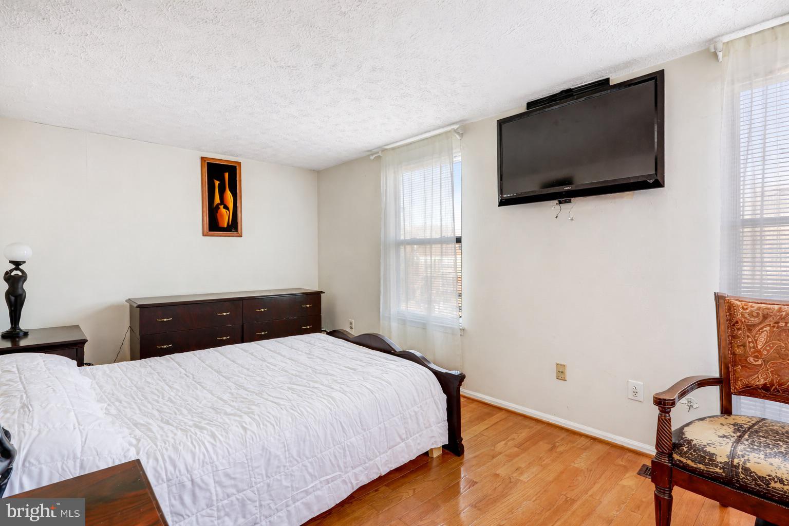 7467 Lone Star Road Lorton, VA 22079 - Photo 8 of 21 a bedroom with a bed and a flat screen tv