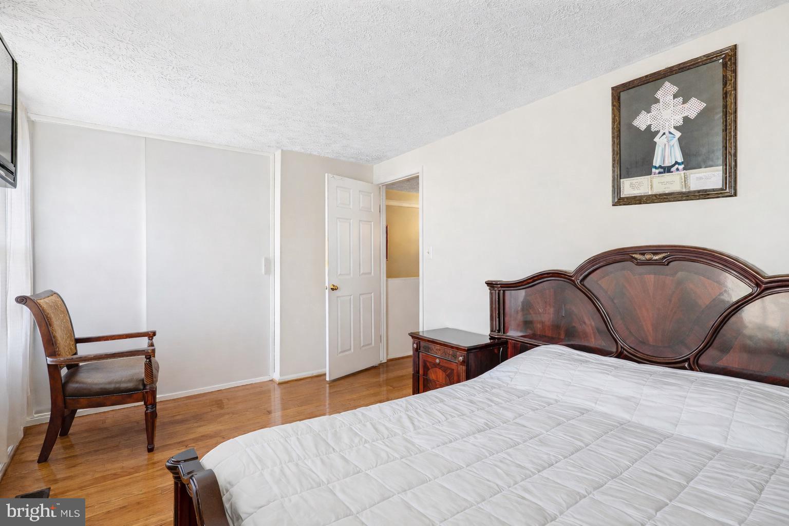 7467 Lone Star Road Lorton, VA 22079 - Photo 9 of 21 a bedroom with a bed and a chair