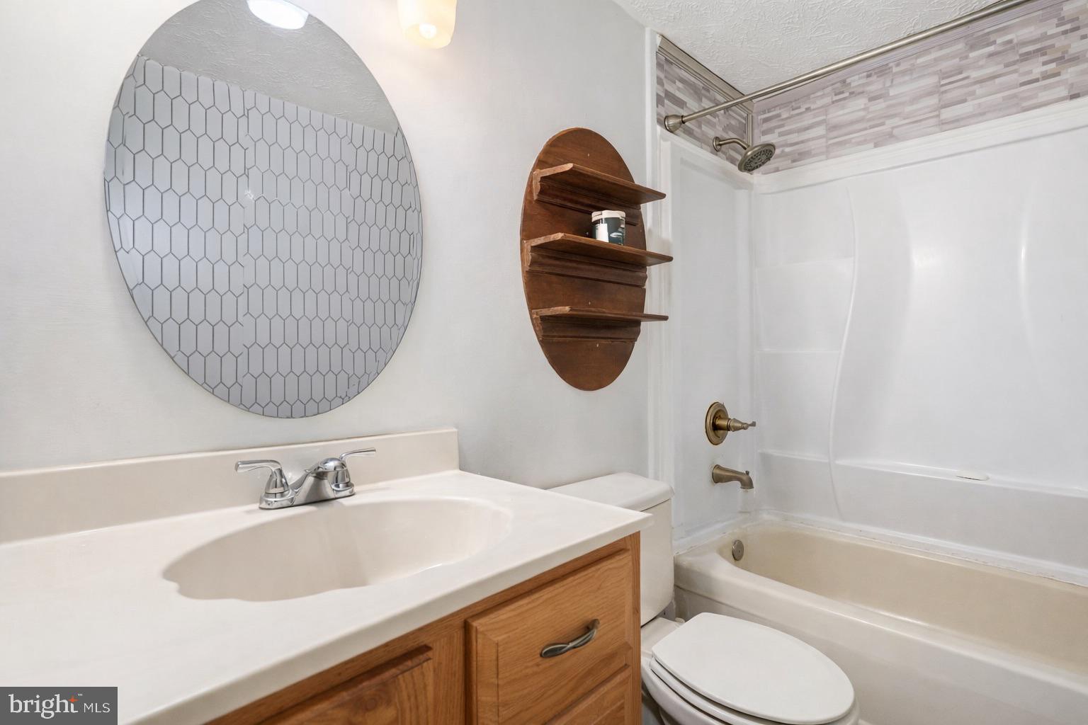 7467 Lone Star Road Lorton, VA 22079 - Photo 10 of 21 a bathroom with a sink toilet and a mirror