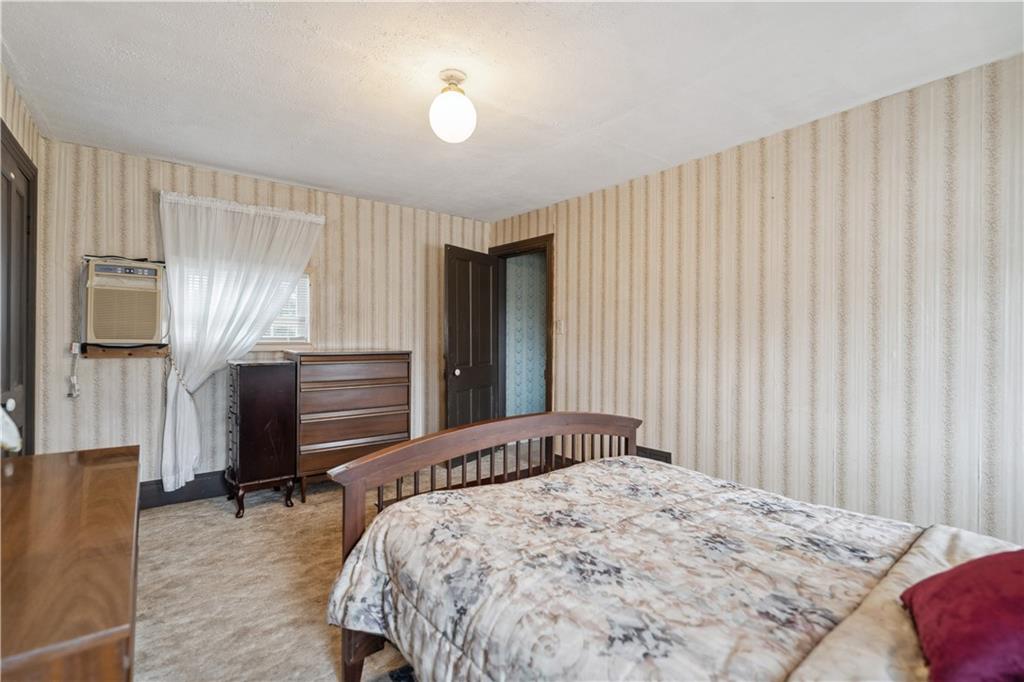 401 Delafayette Street Perryopolis, PA 15473 - Photo 18 of 32 a bedroom with a bed and a chandelier