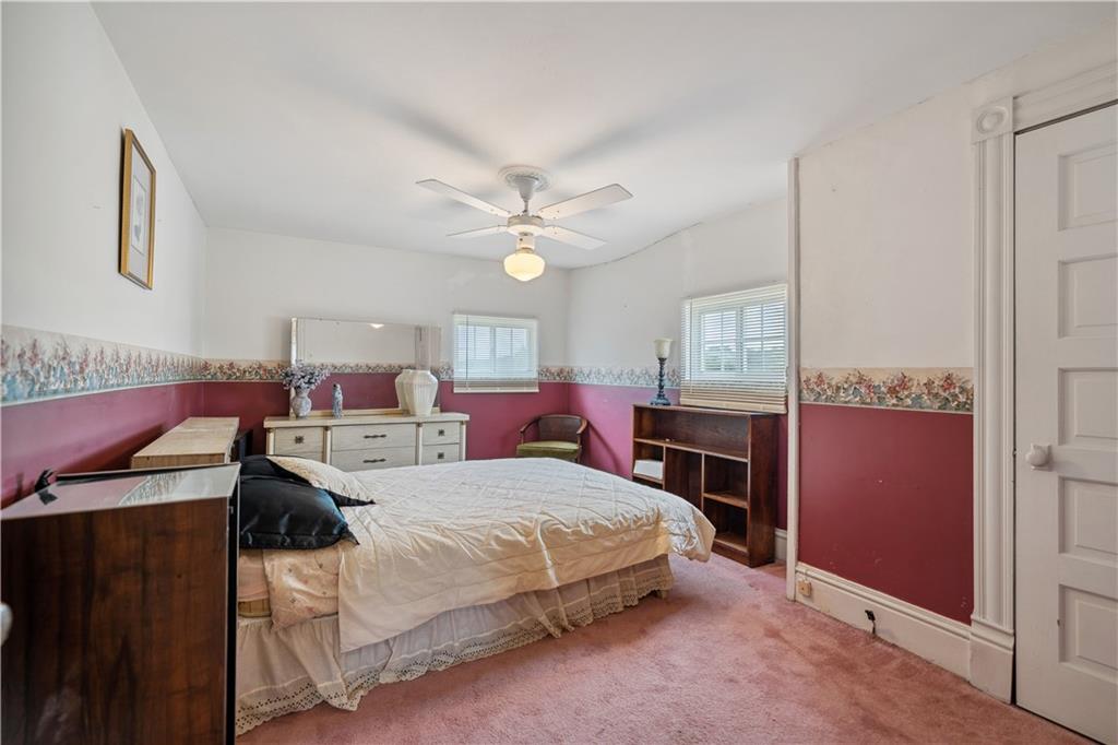 401 Delafayette Street Perryopolis, PA 15473 - Photo 19 of 32 a bedroom with a bed a chandelier and dresser