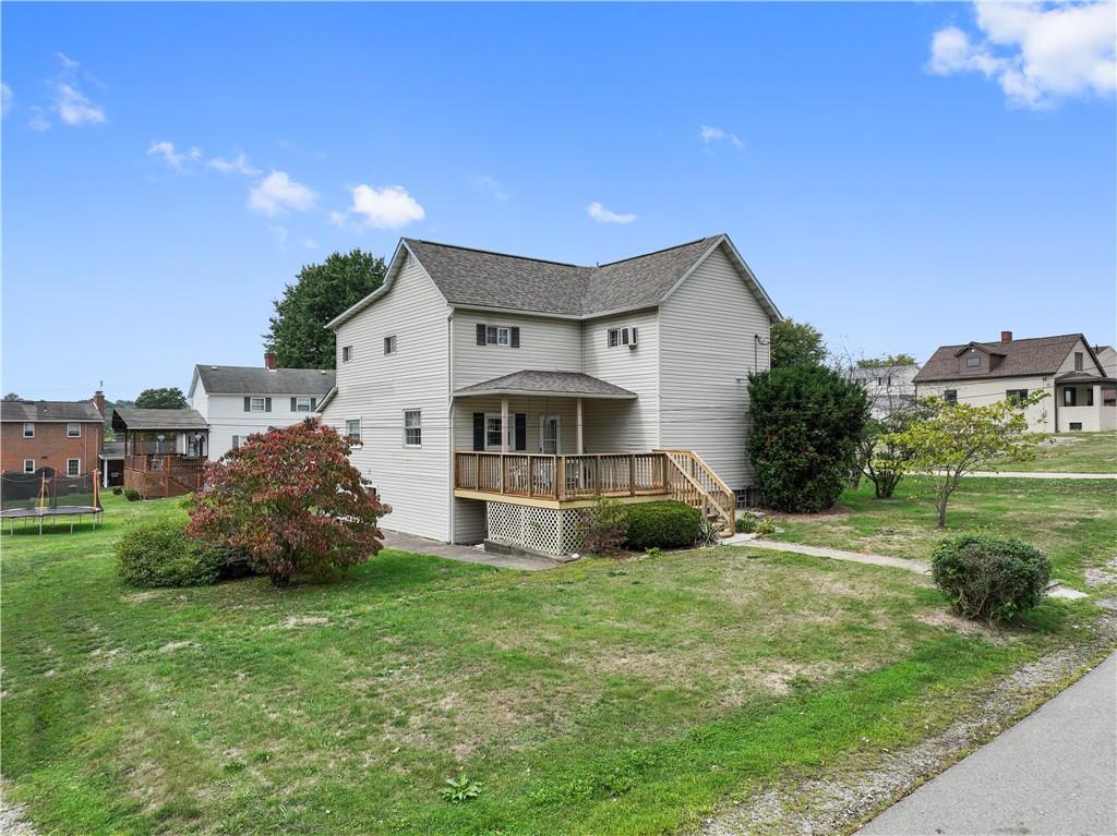 401 Delafayette Street Perryopolis, PA 15473 - Photo 24 of 32 a view of a house with a big yard and large trees