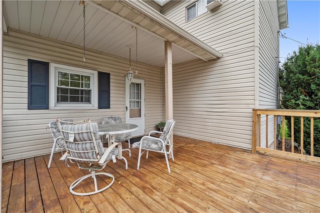 401 Delafayette Street Perryopolis, PA 15473 - Photo 27 of 32 a view of a patio with table and chairs with wooden floor and fence