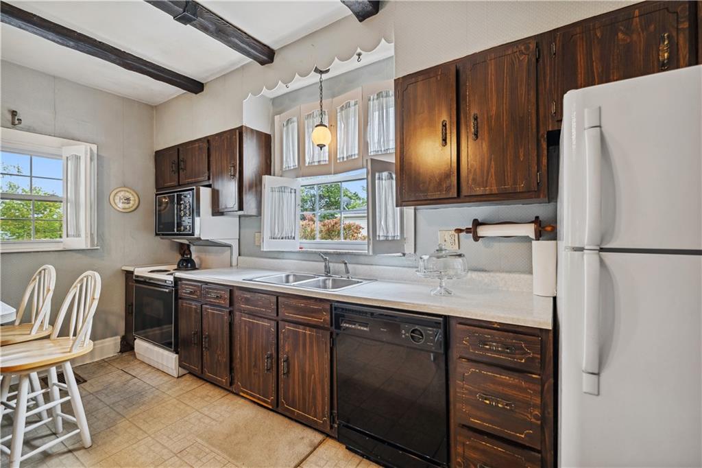 401 Delafayette Street Perryopolis, PA 15473 - Photo 4 of 32 a kitchen with granite countertop a sink stainless steel appliances and cabinets