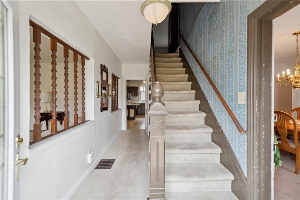 401 Delafayette Street Perryopolis, PA 15473 - Photo 10 of 32 a view of staircase with lots of frames and a rug