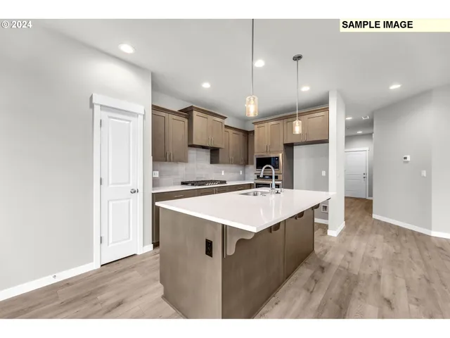 a kitchen with a sink a refrigerator and a stove