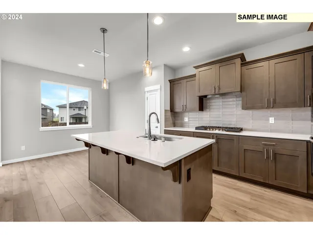 a kitchen with a sink cabinets and window