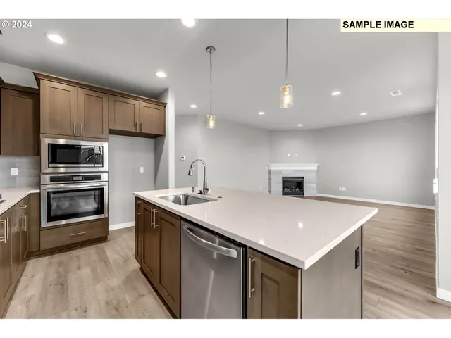 a kitchen with a sink appliances and cabinets