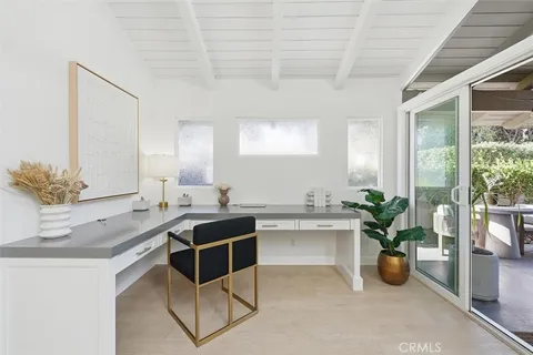 a view of a workspace with furniture and a potted plant