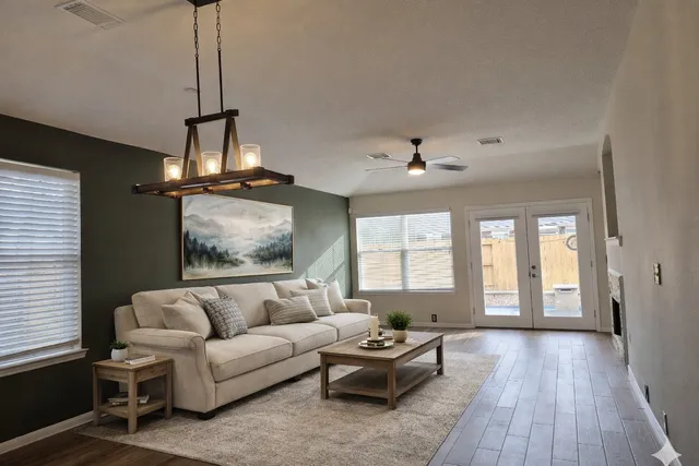 a living room with furniture and a chandelier