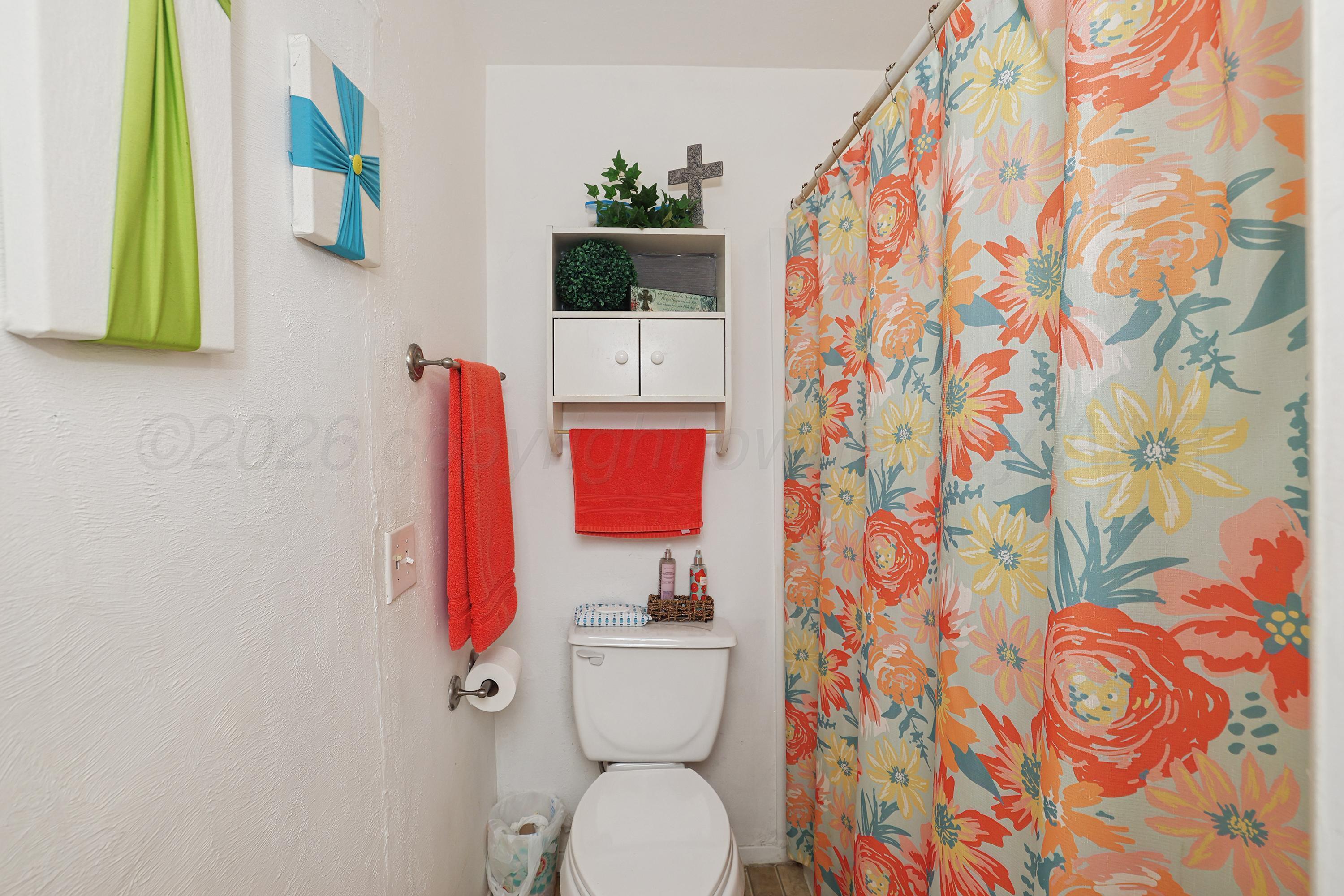 2321 Bell Street Amarillo, TX 79106 - Photo 17 of 24 a bathroom with a toilet and a shower curtain