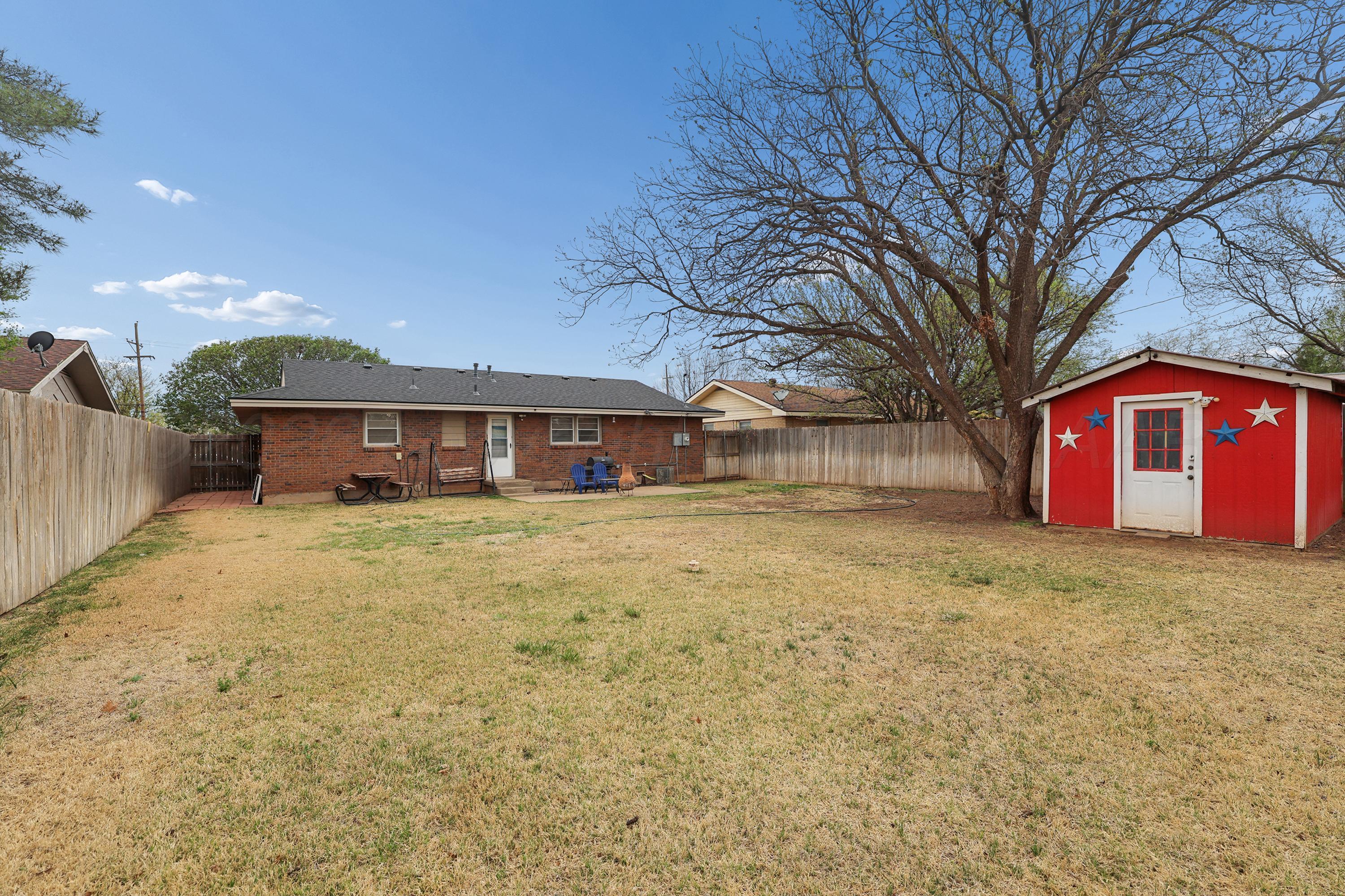 2321 Bell Street Amarillo, TX 79106 - Photo 20 of 24 a front view of a house with a yard and garage