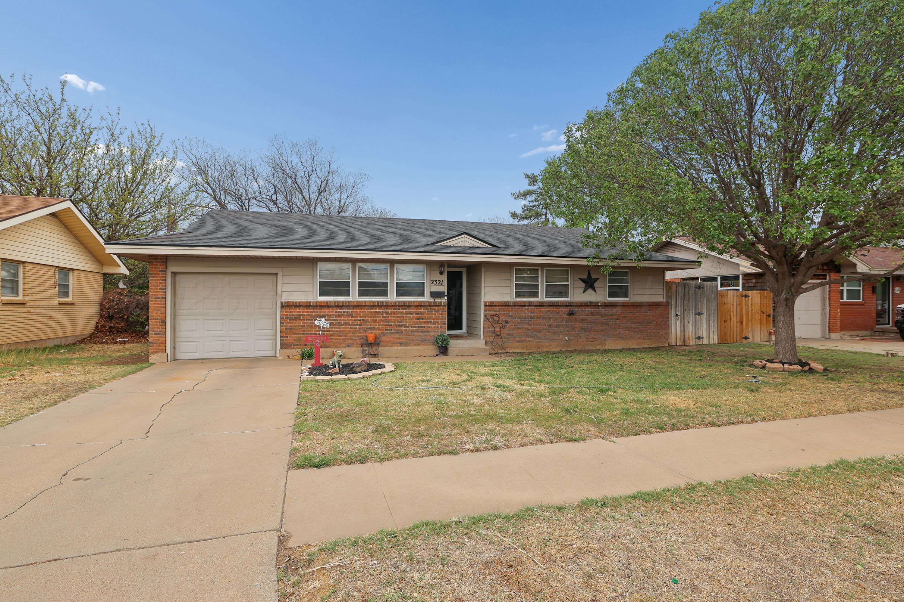 2321 Bell Street Amarillo, TX 79106 - Photo 2 of 24 a view of a house with a yard and large tree
