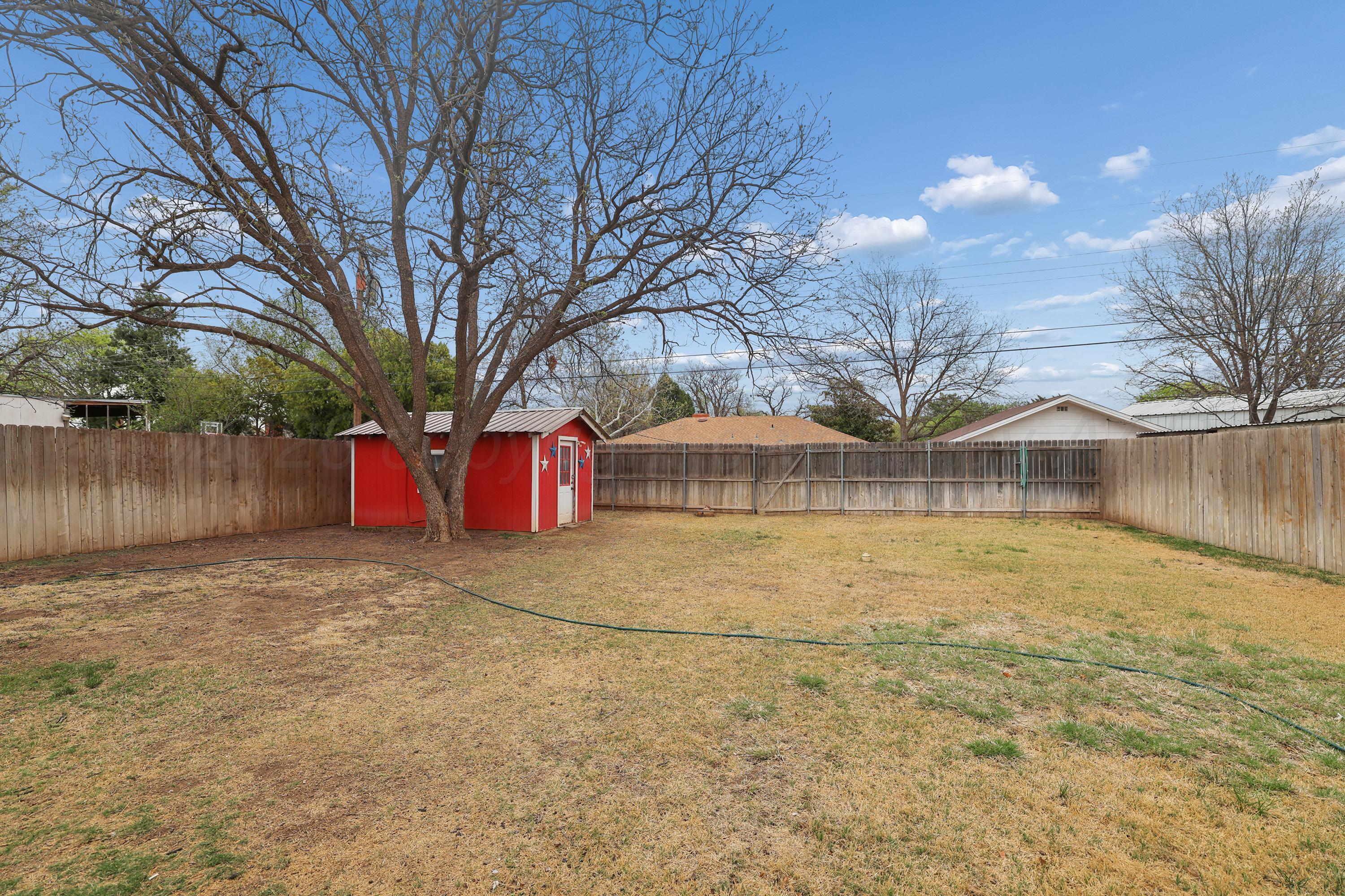 2321 Bell Street Amarillo, TX 79106 - Photo 21 of 24 a front view of a house with a yard and garage