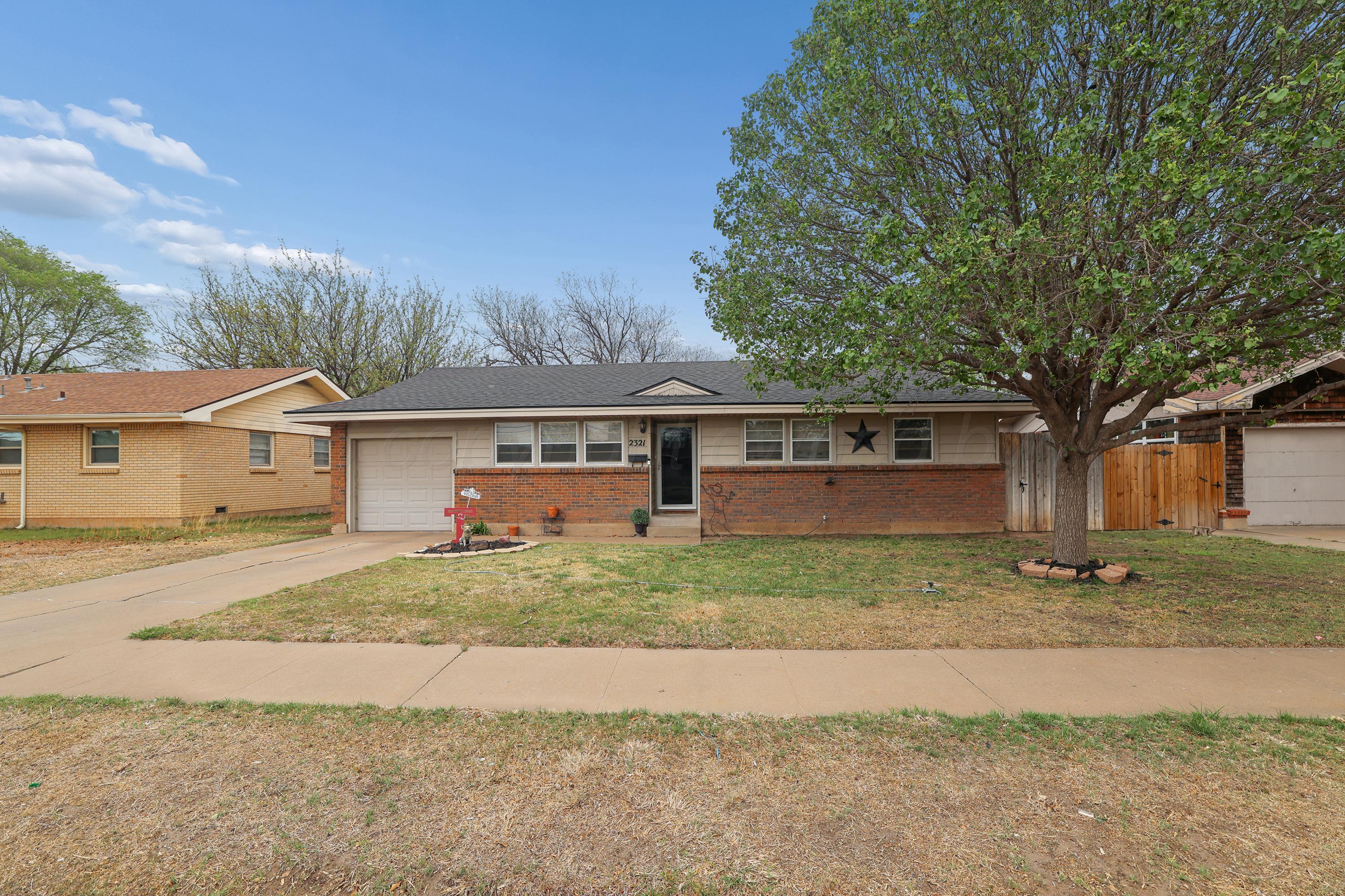 2321 Bell Street Amarillo, TX 79106 - Photo 24 of 24 a front view of a house with a yard and garage