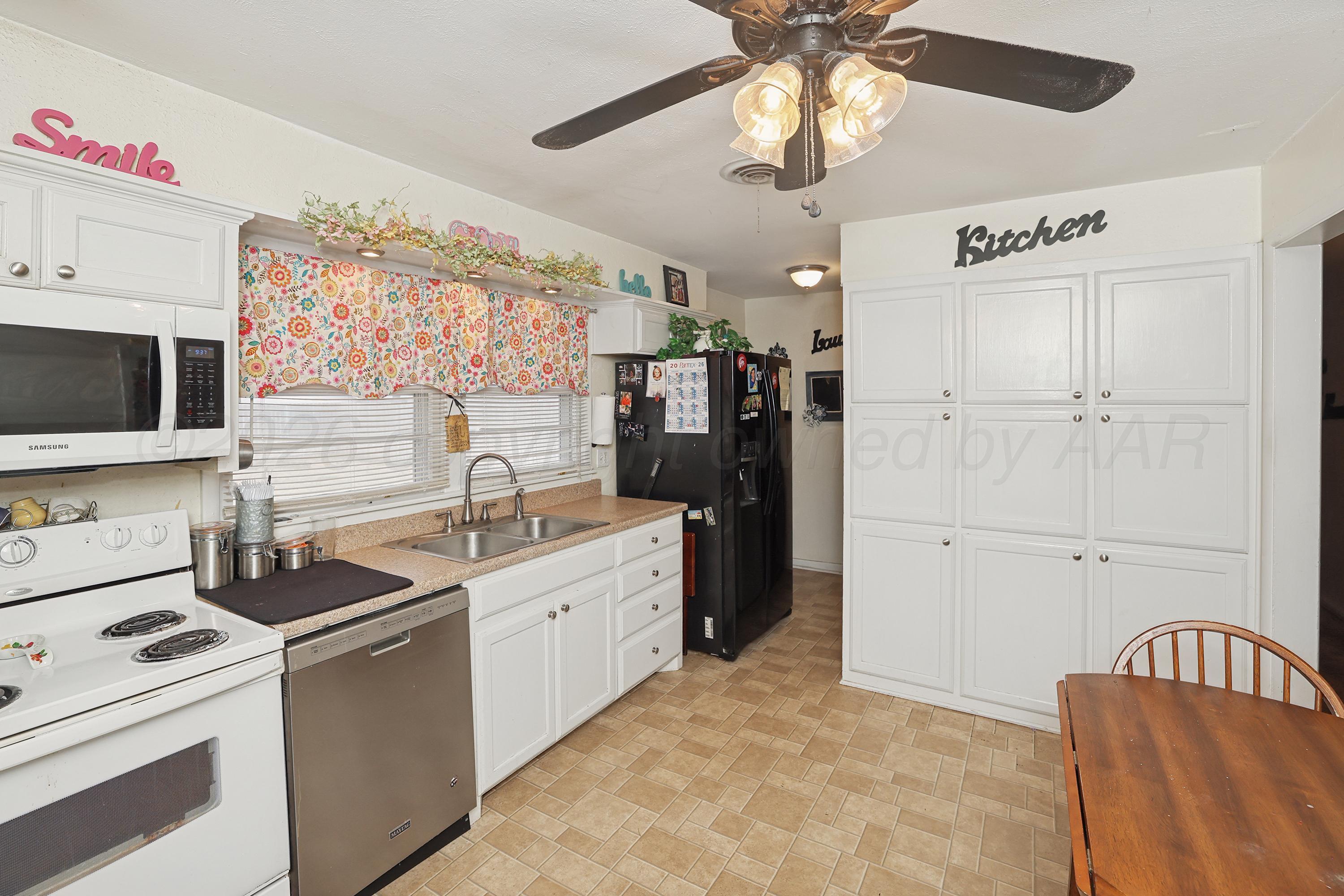 2321 Bell Street Amarillo, TX 79106 - Photo 8 of 24 a kitchen with a refrigerator and a sink