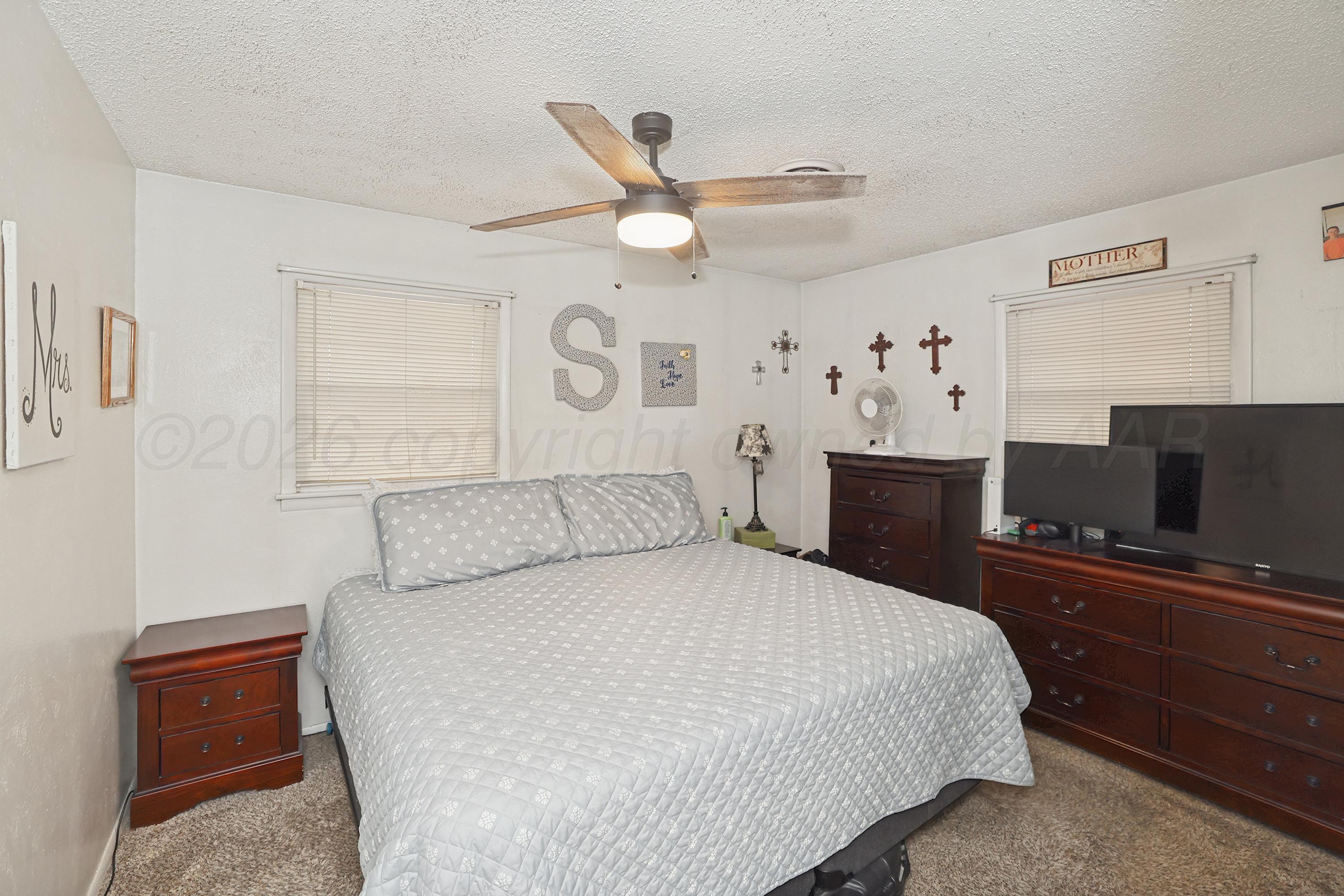 2321 Bell Street Amarillo, TX 79106 - Photo 10 of 24 a bedroom with a bed and a flat screen tv