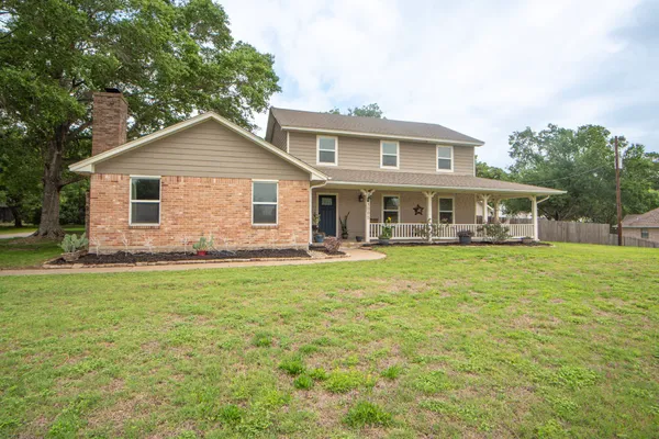 a front view of house with yard and green space