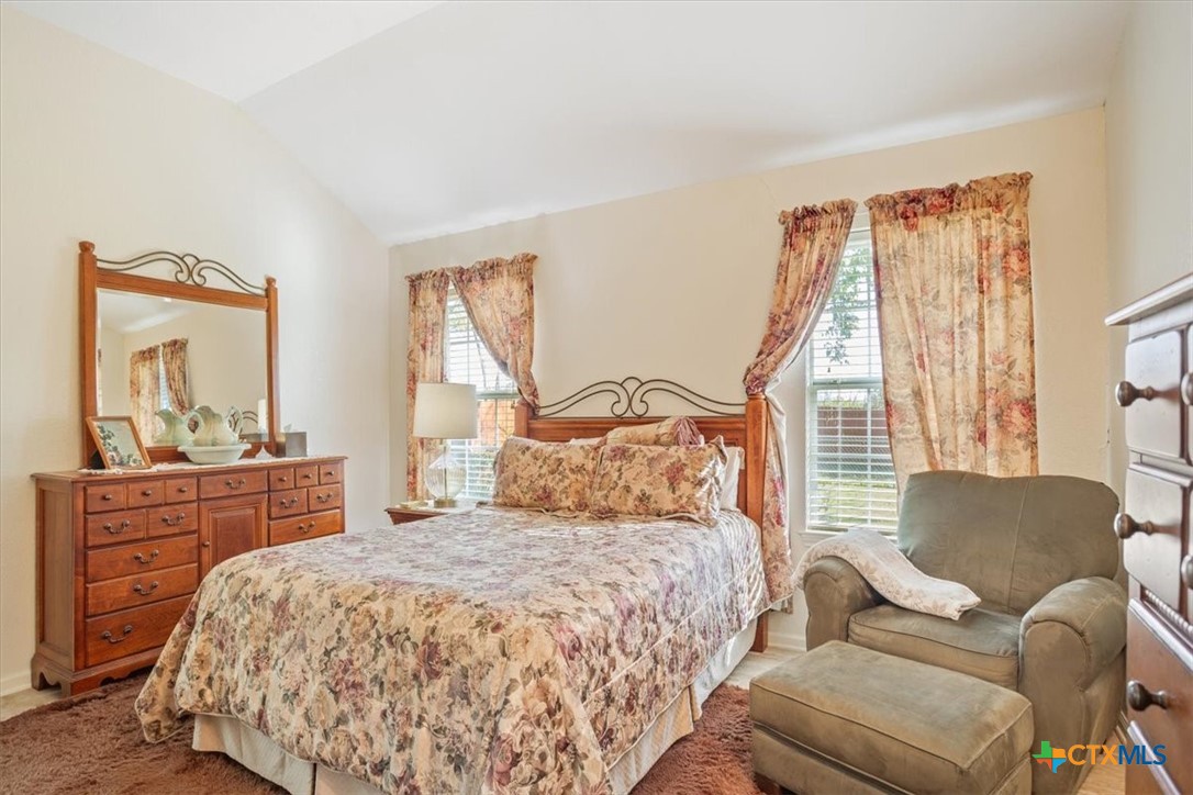 2817 North 12th Street Temple, TX 76501 - Photo 13 of 23 a bedroom with a large bed and a large window