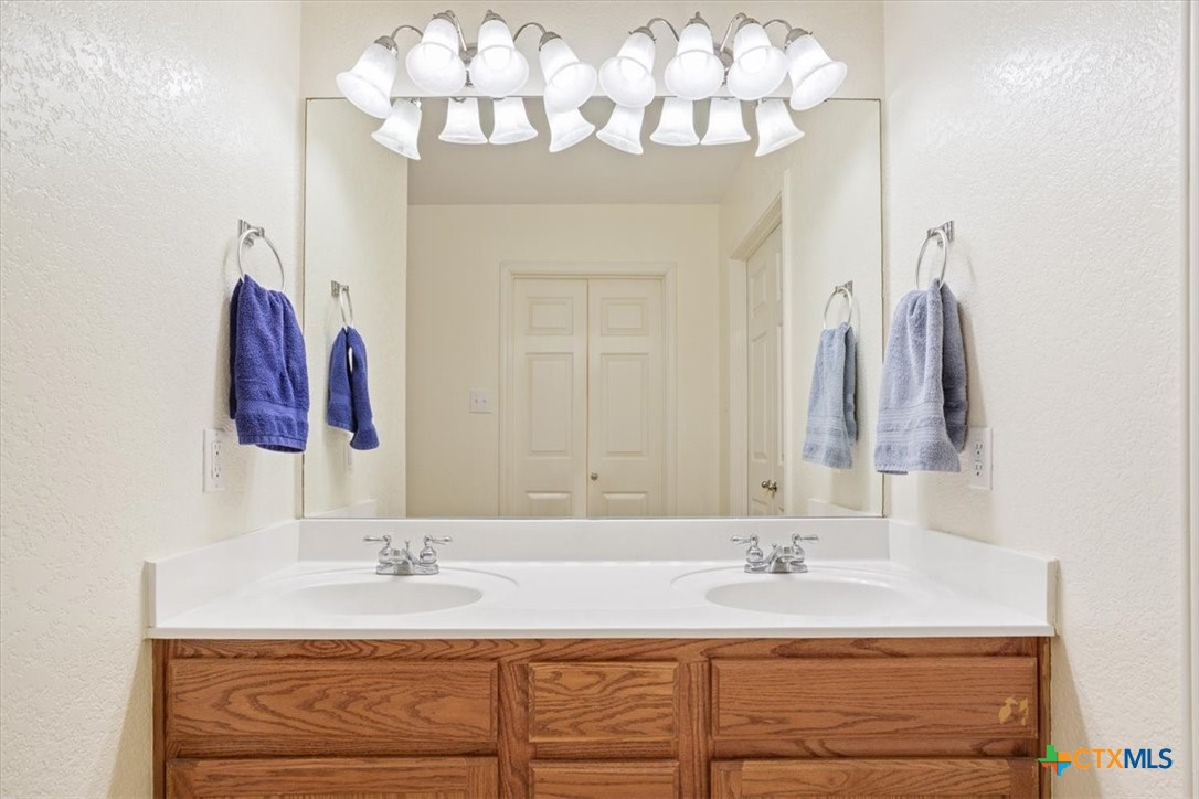 2817 North 12th Street Temple, TX 76501 - Photo 14 of 23 a bathroom with a sink vanity and a mirror